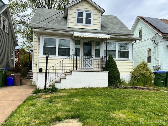 bungalow-style home with a front lawn