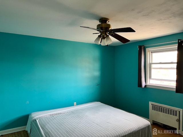 bedroom with radiator and ceiling fan