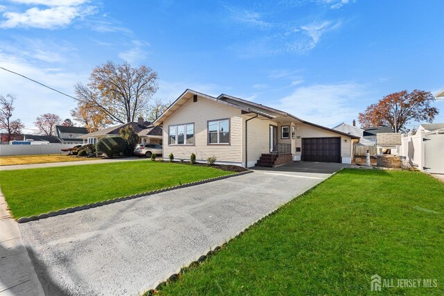 view of front of property with a garage and a front yard