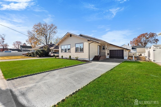 single story home with an attached garage, fence, driveway, and a front lawn