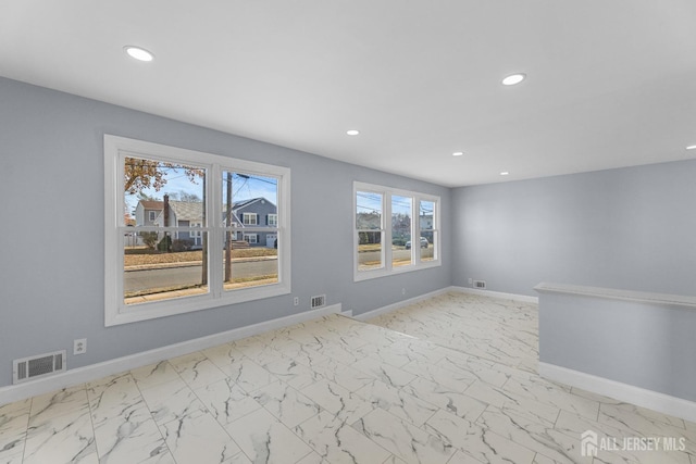 unfurnished room featuring marble finish floor, recessed lighting, visible vents, and baseboards