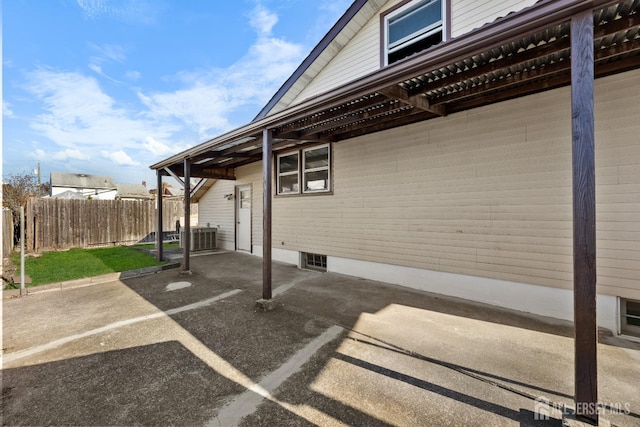 exterior space with fence and central AC unit