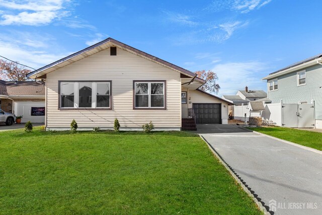 view of front of home featuring a garage and a front lawn