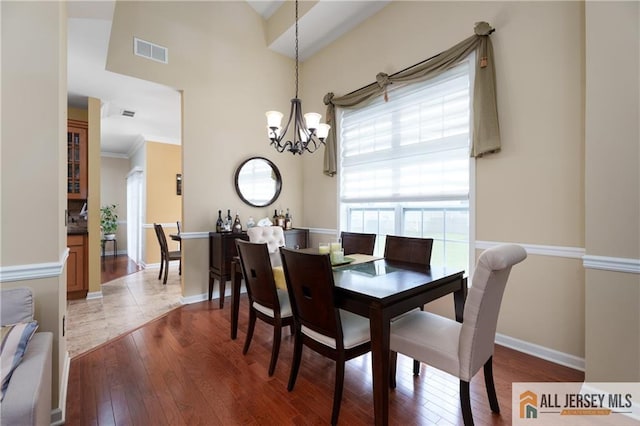 704 Schindler Dr, South Brunswick, NJ 08852 - dining space with a chandelier, hardwood / wood-style flooring, and a towering ceiling