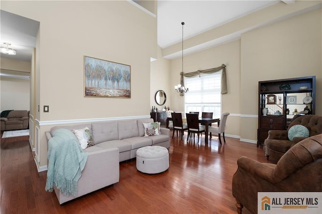 704 Schindler Dr, South Brunswick, NJ 08852 - living area with a chandelier, wood finished floors, and a high ceiling