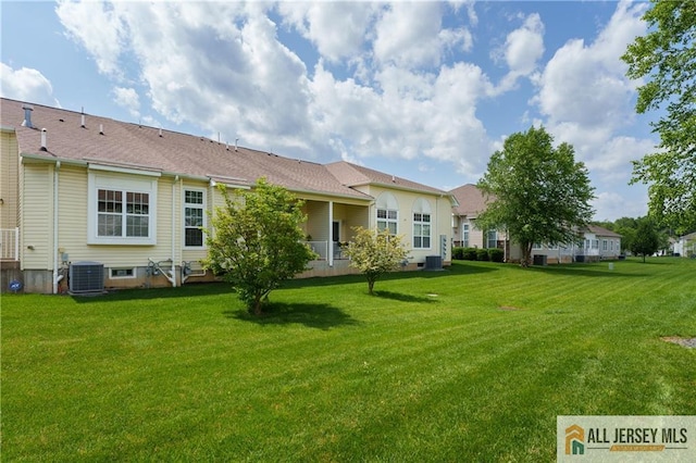704 Schindler Dr, South Brunswick, NJ 08852 - rear view of property with a lawn