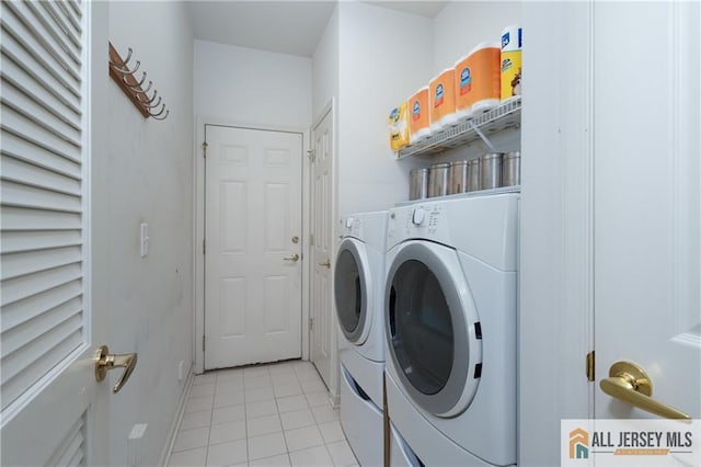704 Schindler Dr, South Brunswick, NJ 08852 - laundry area featuring washing machine and clothes dryer and light tile patterned floors