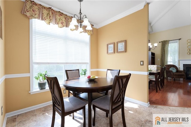 704 Schindler Dr, South Brunswick, NJ 08852 - dining space featuring a chandelier, a fireplace, beam ceiling, crown molding, and light tile patterned flooring