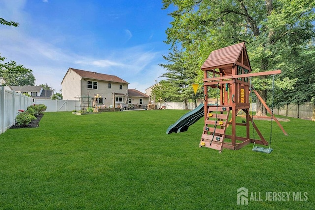 61 Lynn Ct, North Brunswick, NJ 08902 - fenced backyard featuring a playground