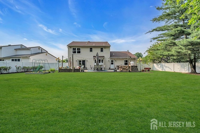 61 Lynn Ct, North Brunswick, NJ 08902 - back of house featuring a garden, a fenced backyard, and a patio