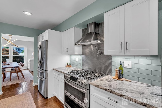 61 Lynn Ct, North Brunswick, NJ 08902 - kitchen with wall chimney range hood, appliances with stainless steel finishes, light stone countertops, dark wood-style floors, and white cabinets