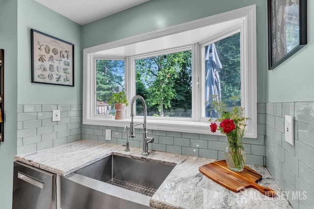 61 Lynn Ct, North Brunswick, NJ 08902 - kitchen with backsplash, light stone counters, and stainless steel dishwasher
