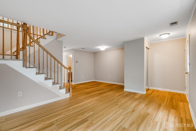 1604 Mulberry Ct, South Brunswick, NJ 08852 - unfurnished living room with wood finished floors, stairway, and crown molding