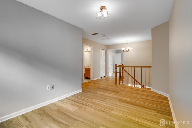 1604 Mulberry Ct, South Brunswick, NJ 08852 - empty room featuring light wood-style floors and a chandelier