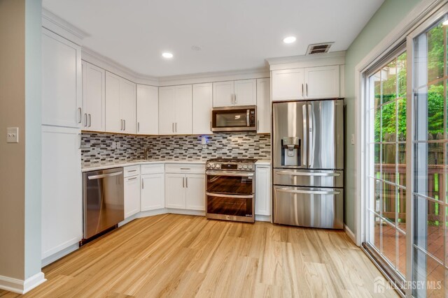 1604 Mulberry Ct, South Brunswick, NJ 08852 - kitchen with stainless steel appliances, light wood-style floors, light countertops, white cabinetry, and recessed lighting