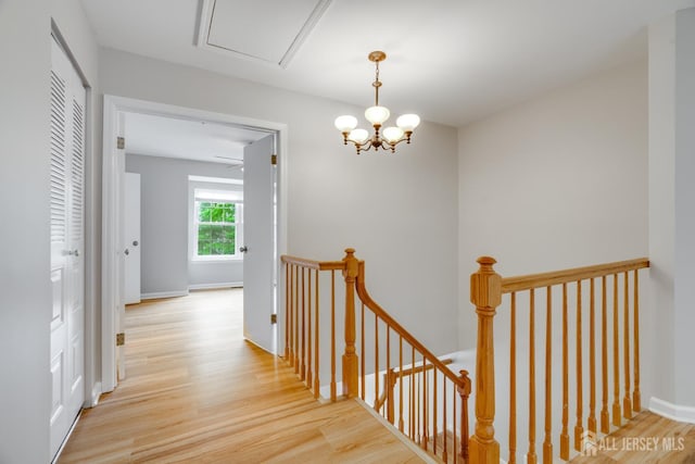 1604 Mulberry Ct, South Brunswick, NJ 08852 - hallway with an upstairs landing, wood finished floors, and a chandelier