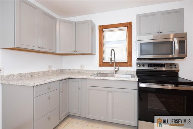 604 Greenwood Ave, Old Bridge, NJ 08879 - kitchen with stainless steel appliances, gray cabinets, a sink, and light tile patterned flooring