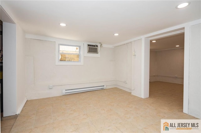below grade area with a baseboard heating unit, an AC wall unit, and recessed lighting
