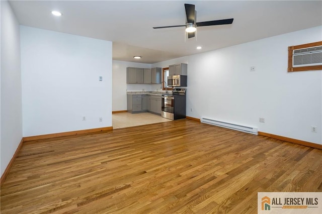 unfurnished living room featuring light wood-style flooring, ceiling fan, baseboards, and baseboard heating