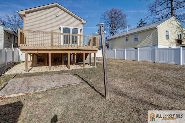 rear view of property featuring a patio, a deck, and a fenced backyard