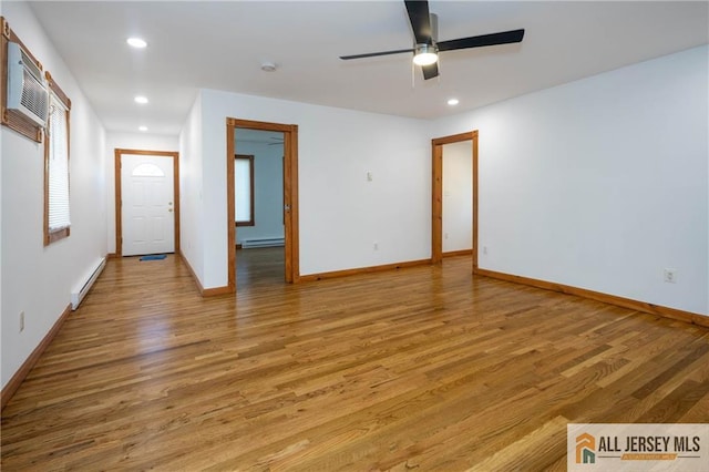 spare room with light wood finished floors, a baseboard heating unit, a ceiling fan, and recessed lighting