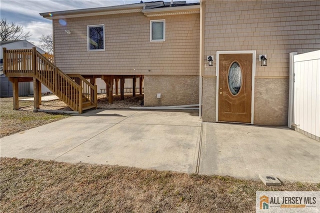 entrance to property featuring a patio