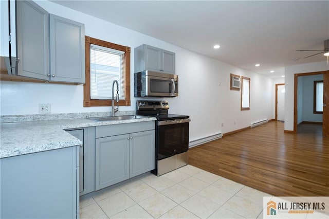 604 Greenwood Ave, Old Bridge, NJ 08879 - kitchen with stainless steel appliances, a sink, a baseboard radiator, light countertops, and recessed lighting
