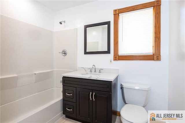 bathroom featuring toilet, shower / bathing tub combination, and vanity