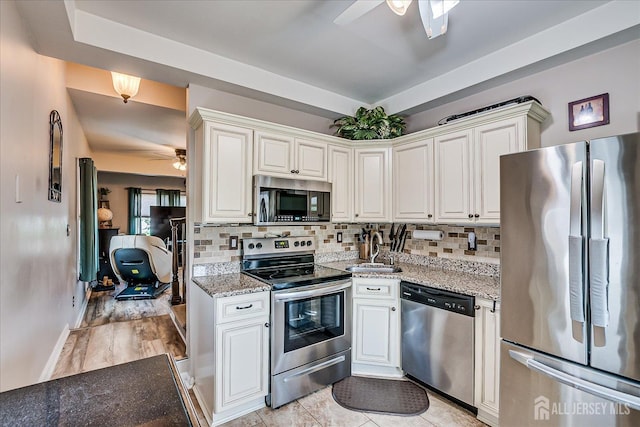 97 Boehmhurst Ave, Sayreville, NJ 08872 - kitchen featuring stainless steel appliances, a ceiling fan, backsplash, and light stone countertops