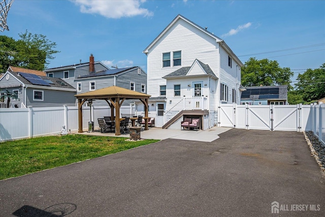 97 Boehmhurst Ave, Sayreville, NJ 08872 - back of property featuring a gate, a gazebo, a patio, and a fenced backyard