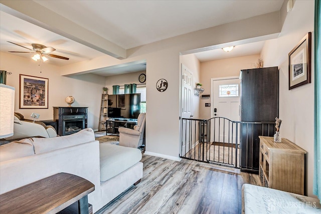 97 Boehmhurst Ave, Sayreville, NJ 08872 - living room with wood finished floors, a ceiling fan, beam ceiling, and a glass covered fireplace