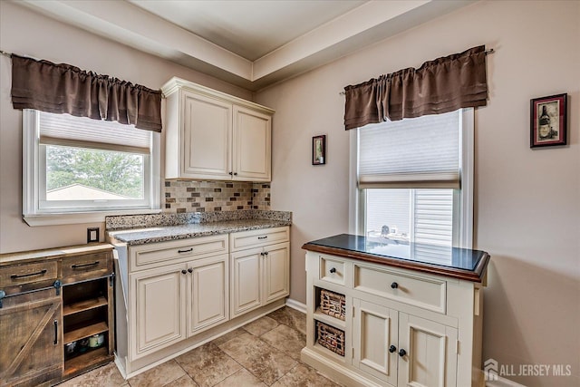 97 Boehmhurst Ave, Sayreville, NJ 08872 - kitchen with backsplash, light stone counters, and cream cabinets