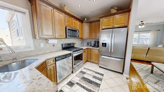 45 Maryknoll Rd, Menlo Park Terrace, NJ 08840 - kitchen with appliances with stainless steel finishes, a sink, light stone counters, and tasteful backsplash
