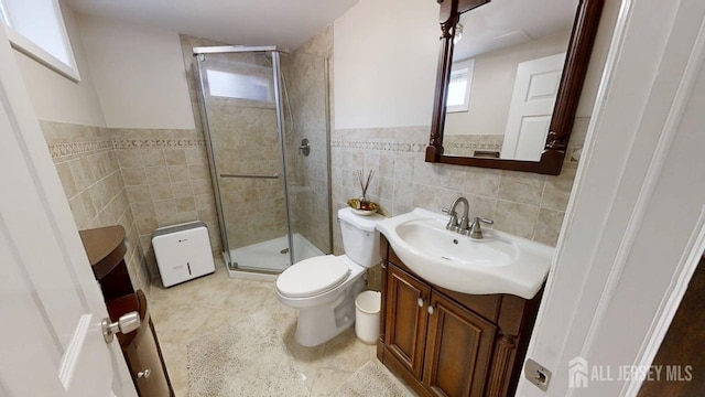 45 Maryknoll Rd, Menlo Park Terrace, NJ 08840 - bathroom with tile walls, a stall shower, vanity, toilet, and tile patterned flooring