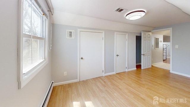 45 Maryknoll Rd, Menlo Park Terrace, NJ 08840 - unfurnished bedroom featuring light wood-style flooring, baseboards, multiple closets, and baseboard heating