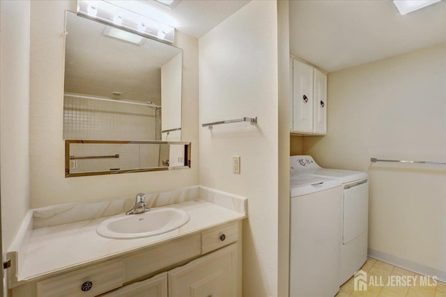 bathroom featuring independent washer and dryer and vanity