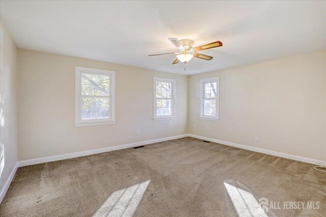 empty room featuring ceiling fan and carpet floors