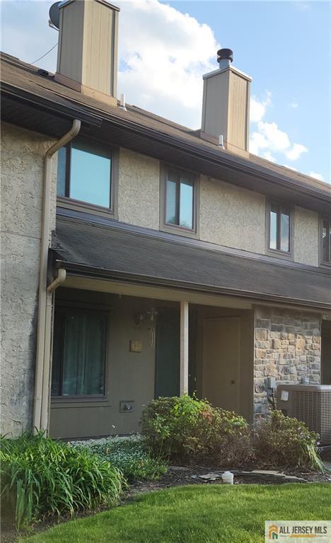 134 Hampshire Dr, Plainsboro, NJ 08536 - back of property featuring a chimney and stucco siding