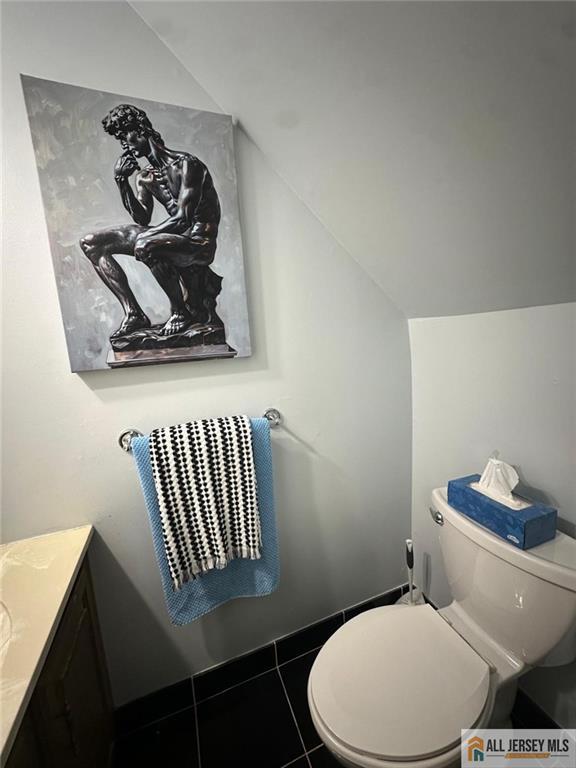 134 Hampshire Dr, Plainsboro, NJ 08536 - half bath featuring lofted ceiling, vanity, and tile patterned flooring