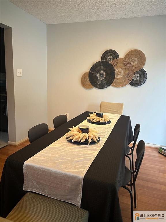 134 Hampshire Dr, Plainsboro, NJ 08536 - dining space featuring wood finished floors and a textured ceiling