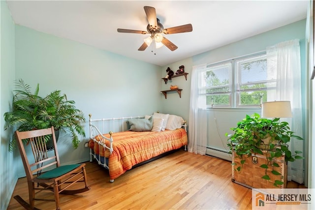 14 Devon Rd, Edison, NJ 08820 - bedroom featuring baseboard heating, wood finished floors, and a ceiling fan