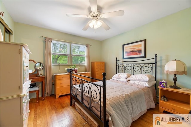 14 Devon Rd, Edison, NJ 08820 - bedroom with light wood-style floors, a ceiling fan, and baseboard heating