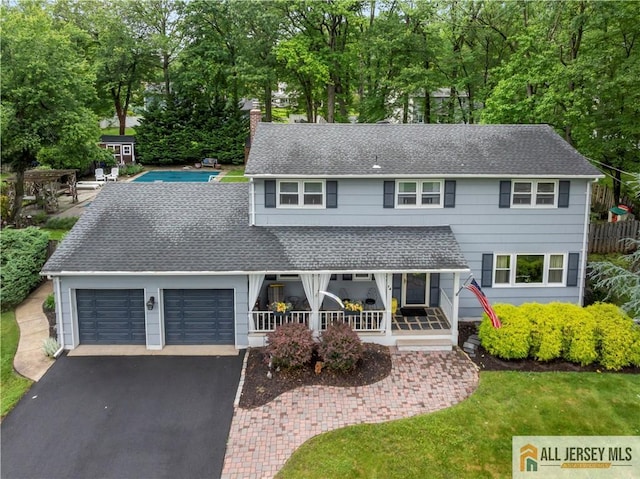 14 Devon Rd, Edison, NJ 08820 - view of front facade featuring driveway, roof with shingles, a chimney, and an attached garage