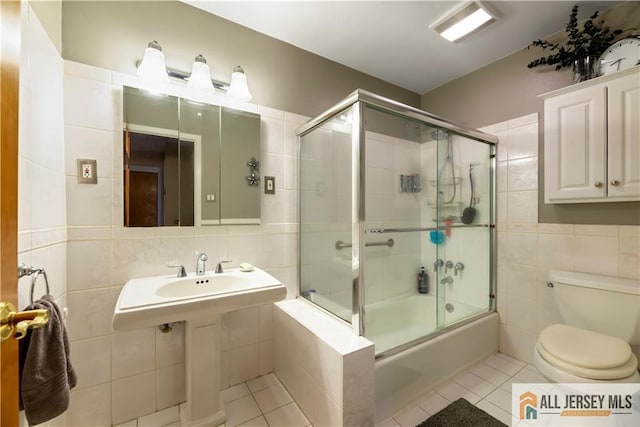 14 Devon Rd, Edison, NJ 08820 - bathroom featuring tile walls, tile patterned flooring, and enclosed tub / shower combo