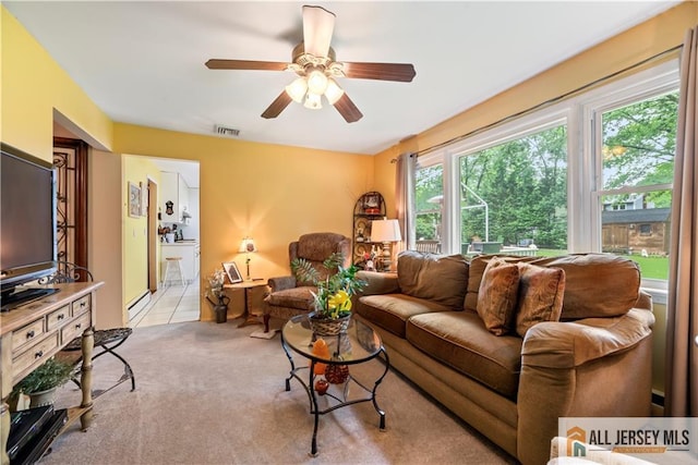 14 Devon Rd, Edison, NJ 08820 - living area featuring a ceiling fan, light colored carpet, baseboard heating, and light tile patterned flooring