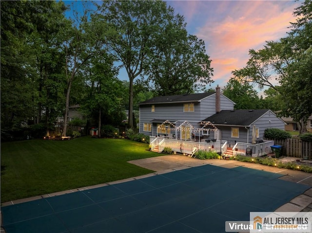 14 Devon Rd, Edison, NJ 08820 - rear view of house featuring a wooden deck, a chimney, and a patio area