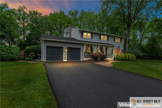 14 Devon Rd, Edison, NJ 08820 - view of front facade featuring an attached garage, a porch, driveway, and a chimney