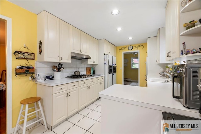 14 Devon Rd, Edison, NJ 08820 - kitchen featuring under cabinet range hood, open shelves, stainless steel gas stovetop, backsplash, and light countertops