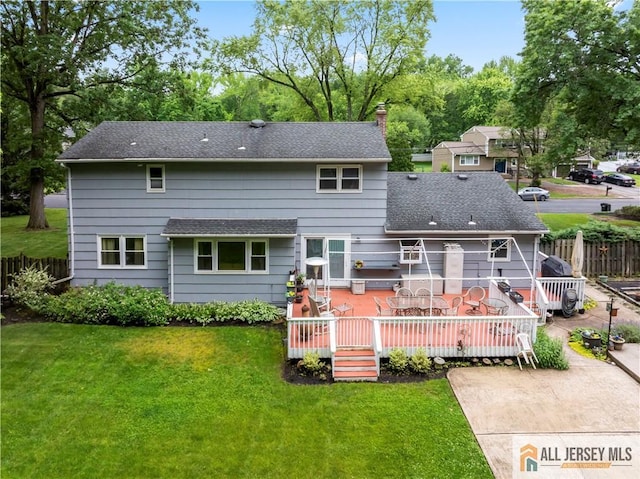 14 Devon Rd, Edison, NJ 08820 - back of property featuring a chimney, a deck, a shingled roof, and a patio area