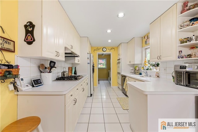 14 Devon Rd, Edison, NJ 08820 - kitchen with open shelves, appliances with stainless steel finishes, light tile patterned floors, under cabinet range hood, and light countertops